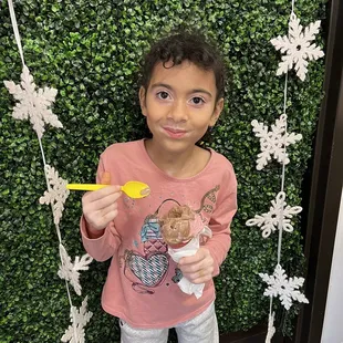 a little girl eating ice cream