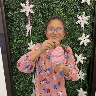 a girl holding a cupcake