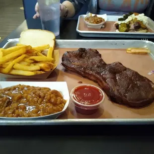 Pork steak, beans, and fries