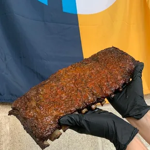 a person holding a large bbq