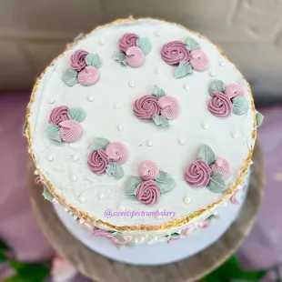 a white cake with pink and green flowers