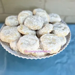 a plate of powdered sugar cookies