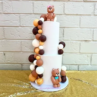 a three tiered cake decorated with teddy bears