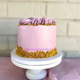 a pink cake with purple frosting