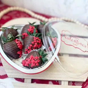 a plate of chocolate covered strawberries
