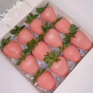 a box of pink strawberries