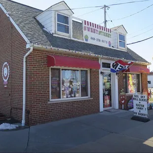 a brick building with a red awning