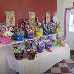 a table with baskets of candy and candies