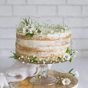 a naked cake with white flowers