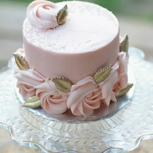 a pink cake on a glass plate