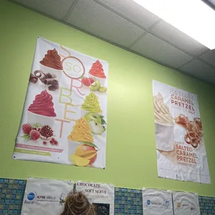 a green wall with posters on it