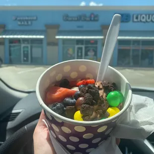 a person holding a cup of ice cream