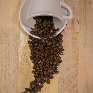 coffee beans spilling out of a cup