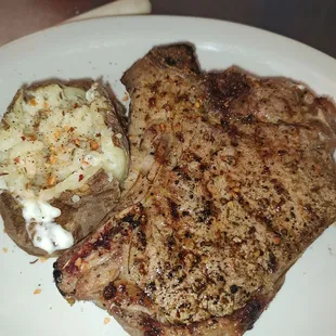 a steak and potatoes on a plate