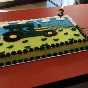 a tractor on a birthday cake