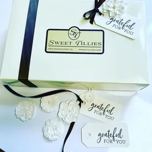 a white box with a black ribbon