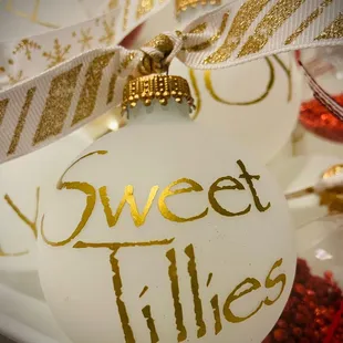 a white ornament with gold lettering