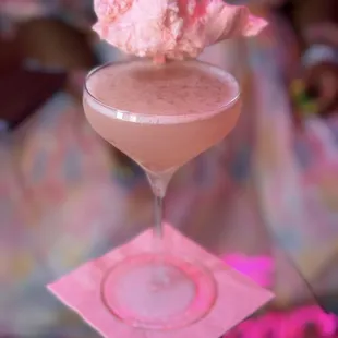 Pink lemonade cosmopolitan with cotton candy as garnish