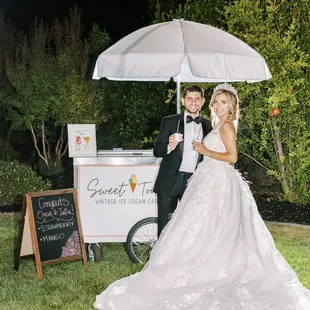 a bride and groom under an umbrella