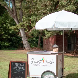 an ice cream cart with an umbrella
