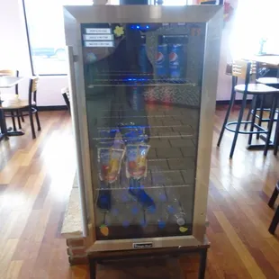 A small cooler with a few beverages.