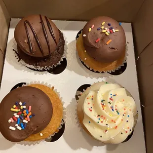 four cupcakes in a box