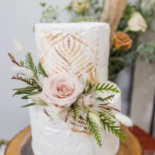 a white wedding cake decorated with flowers