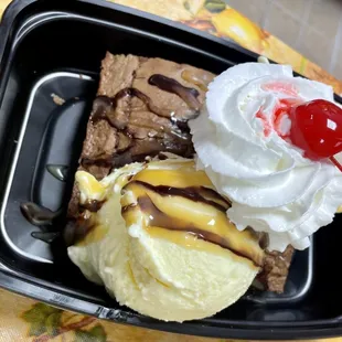 Huge Brownie Sundae with chocolate sauce, Carmel sauce, whipped cream and cherry!
