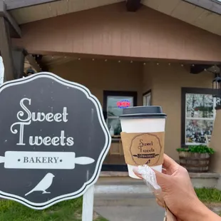 a hand holding a cup of coffee