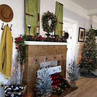 a fireplace decorated for christmas
