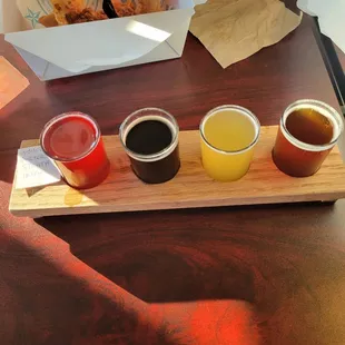 a tray of beer and sauces