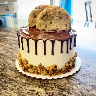 a chocolate chip cookie on top of a cake