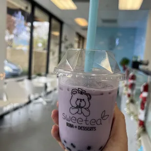 a hand holding a cup of bubble tea