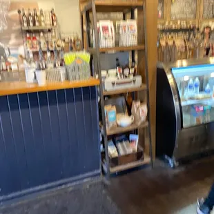 a blurry image of a woman walking past a counter