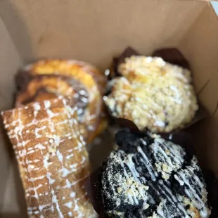 Black bottom and blueberry muffin, apple danish, and cinnamon bun pastry box.