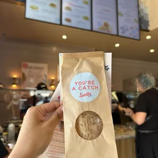 a person holding a bag of cookies
