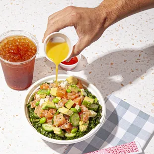 a bowl of salad and a drink