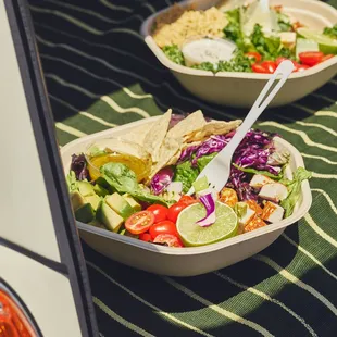 a bowl of salad and a bowl of tortillas