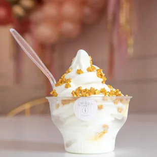 a cup of ice cream with a spoon sticking out of it