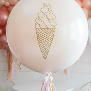 a balloon with a gold ice cream cone on it