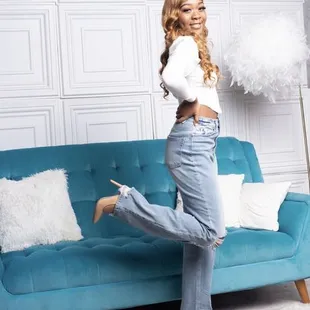 a woman posing on a blue couch