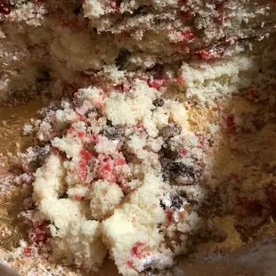 A PILE OF CRUMBS FROM THE DRY CHERRY NUT CAKE WE ORDERED. Every piece, was falling apart because it was so dry (&amp; tasted bad with few nuts)