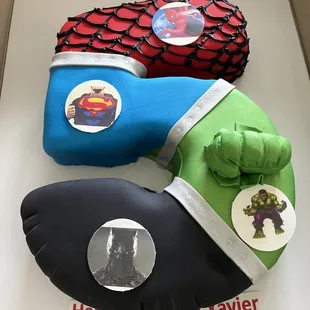 a hulk and superman cake in a box