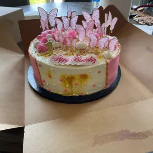 a cake with pink butterflies on top