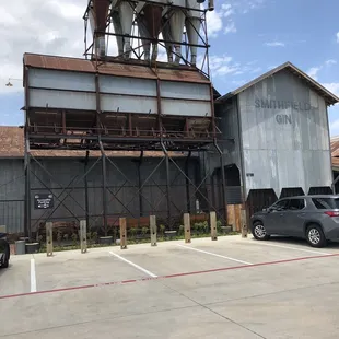 Entrance and outside waiting area. Rear side of building in parking lot.
