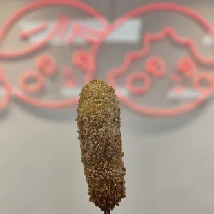 ows a fried chicken on a stick