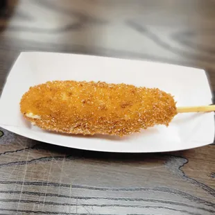 ows a fried chicken on a stick