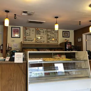 a bakery counter with a display of donuts