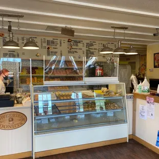 a bakery counter with a pastry display