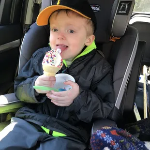 a young boy eating an ice cream cone